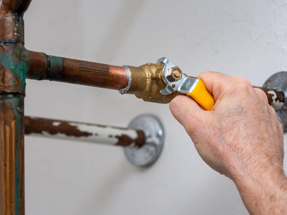 Plumber working on pipes