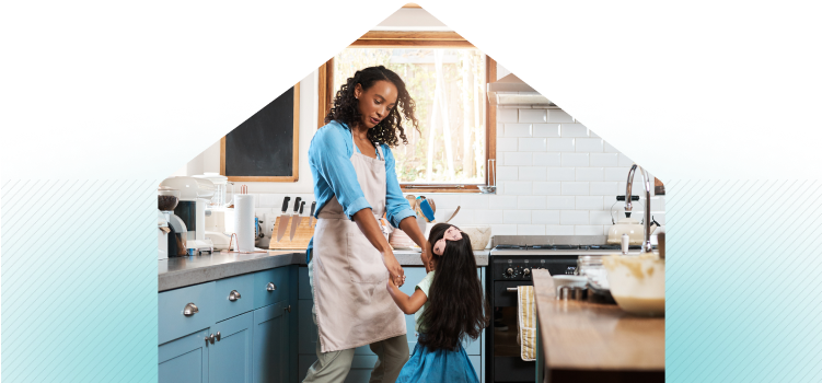Mother and daughter dancing in kitchen